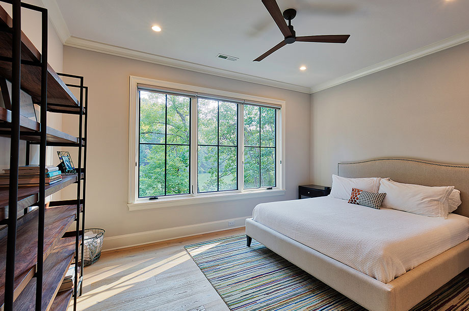 guest suite with large shelving unit against one wall and large windows 