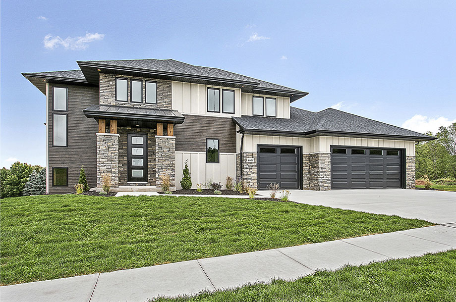 exterior of custom multi-story brick house with turfgrass lawn