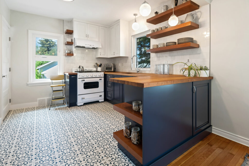 full kitchen renovation with blue cupboards and cherry wood counter tops and open shelving