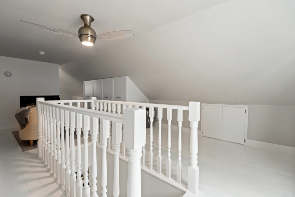attic with stair and ceiling and fan