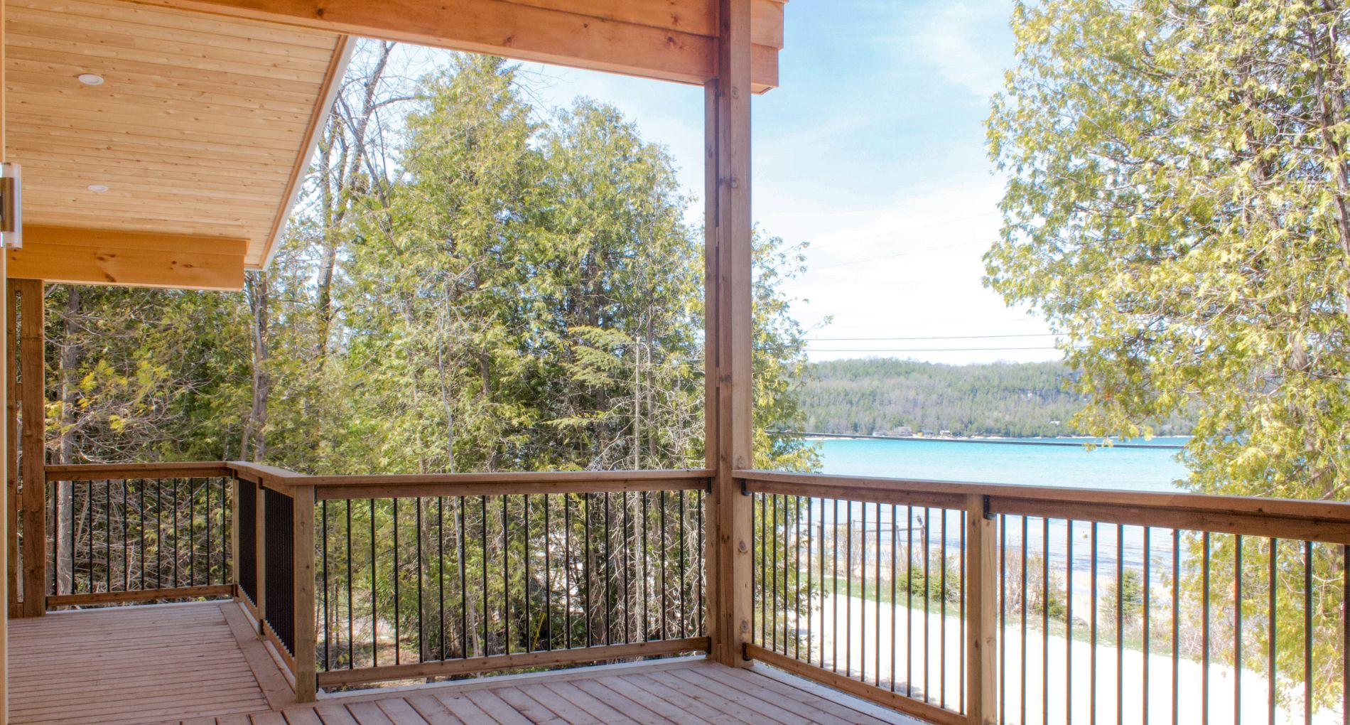 Modern Lakehouse with Warm Wood Finishes and Covered Deck