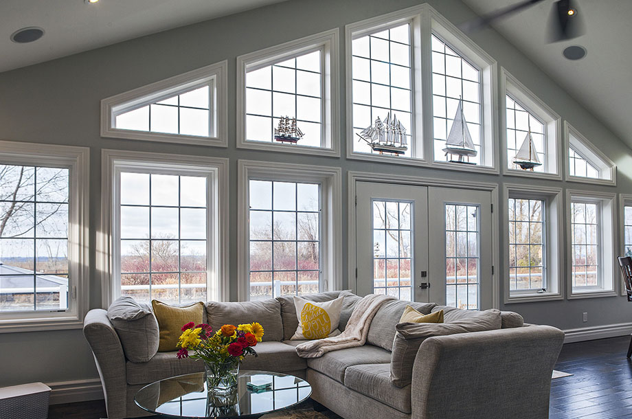 living area of luxury custom home with floor to ceiling windows letting in natural light