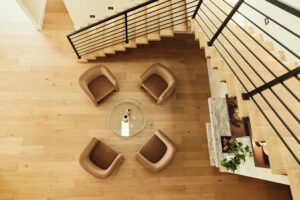 4 swivel chairs set up at the bottom of the staircase