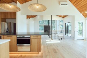 Kirkland Home Renovation Trends: a stunning modern open concept kitchen and dining room with vaulted ceilings covered in wood paneling