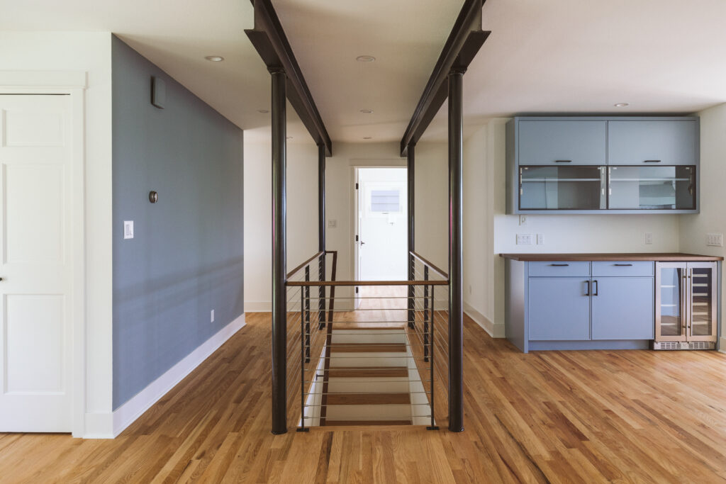 open floor plan, staircase and a modern dry bar design in a custom home by Alair Homes Kirkland