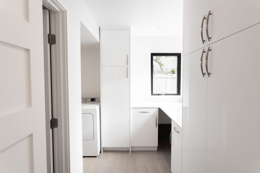 white custom cabinets in a laundry room by Alair Homes Kirkland