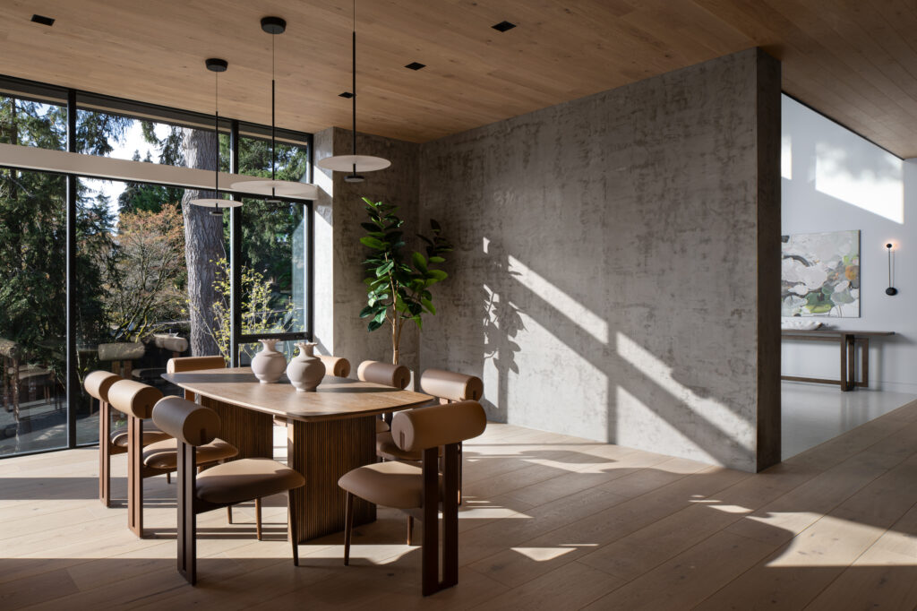 a dining room with floor-to-ceiling windows in a designer home on lake washington | Alair Homes Kirkland