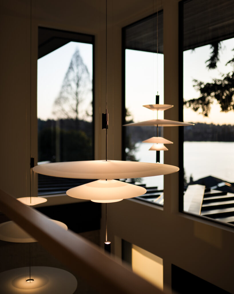 the Flamingo Chandeliers hanging above the stairs in a custom home on lake washington built by Stacy Eakman