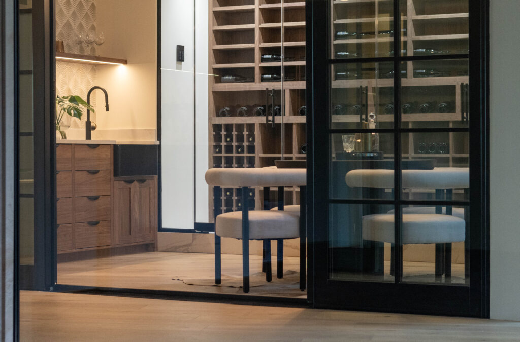 one of the wine room design ideas for your custom home in Shoreline WA is adding floating shelves to your modern wet bar to display your glassware