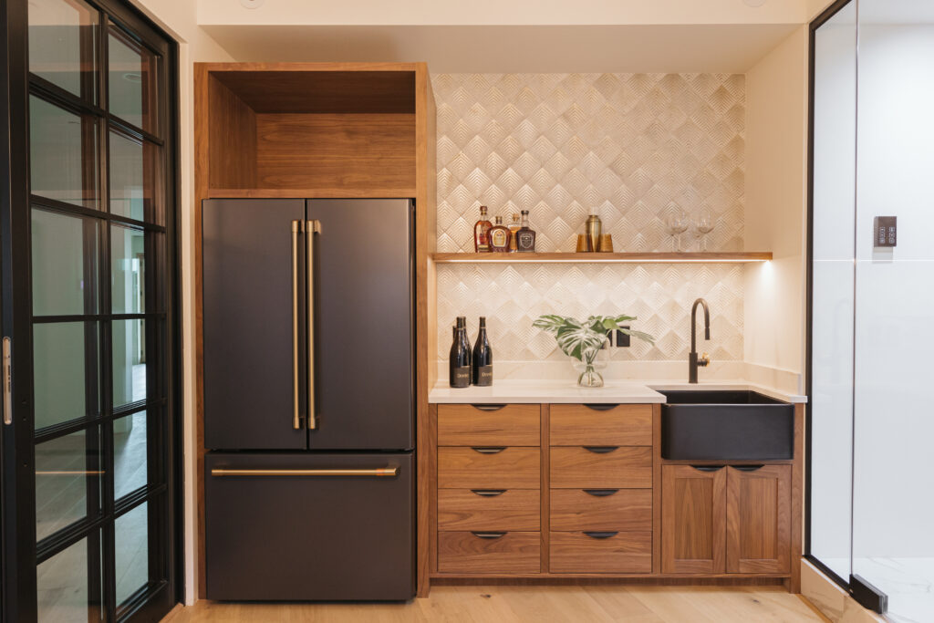 One of the wine room design ideas is adding a modern wet bar to your wine room