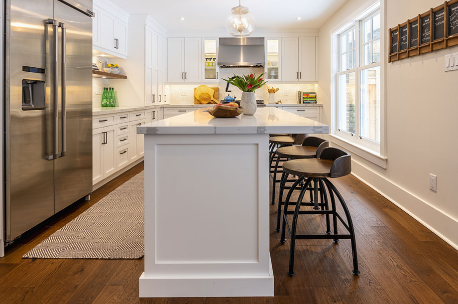 custom kitchen with large white island bright decor and dark vinyl flooring