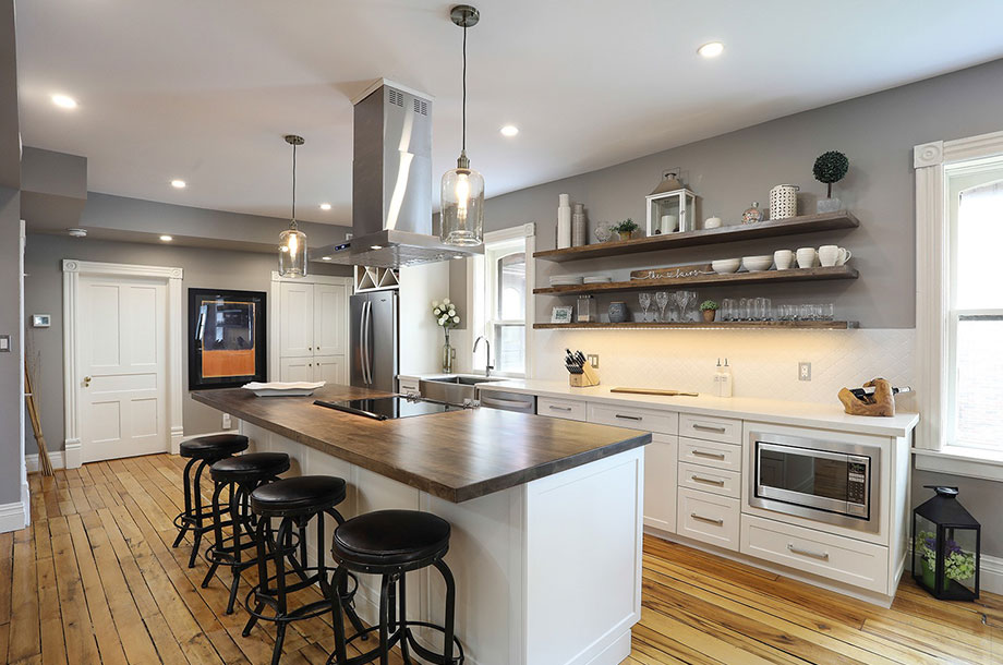 Kitchen Renovation with large island, white custom cabinetry, and stainless steel appliances