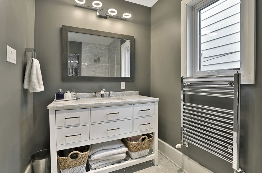 guest bathroom complete with space for extra towels and toiletries below sink
