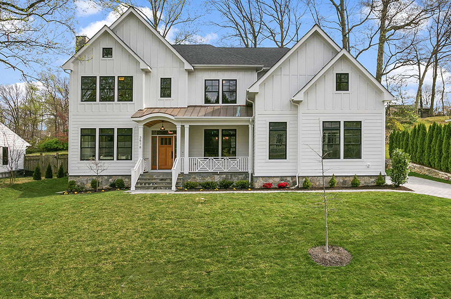 exterior of with custom home with turfgrass front lawn