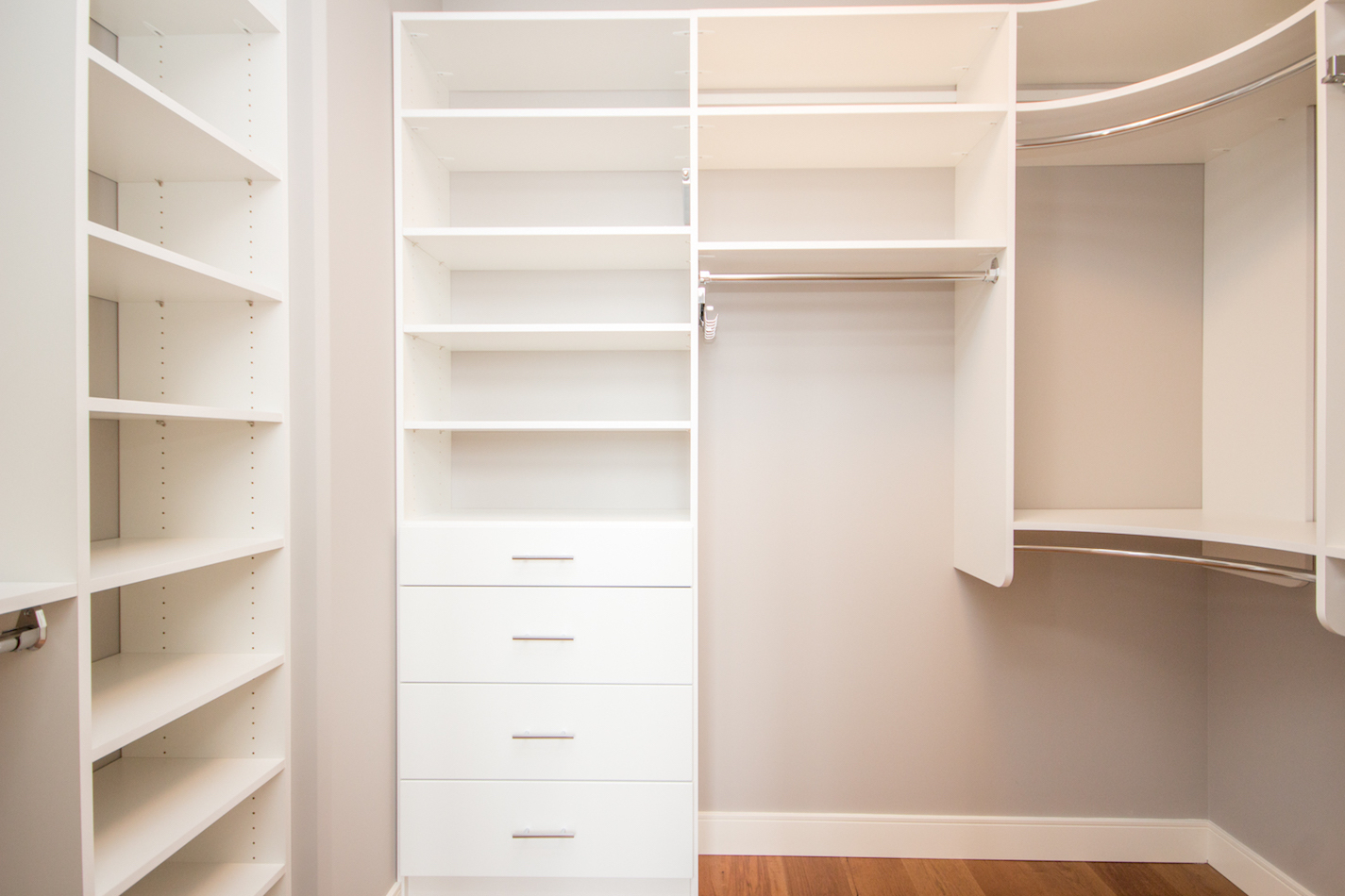 custom closet with built in shelving and additional hanging rods