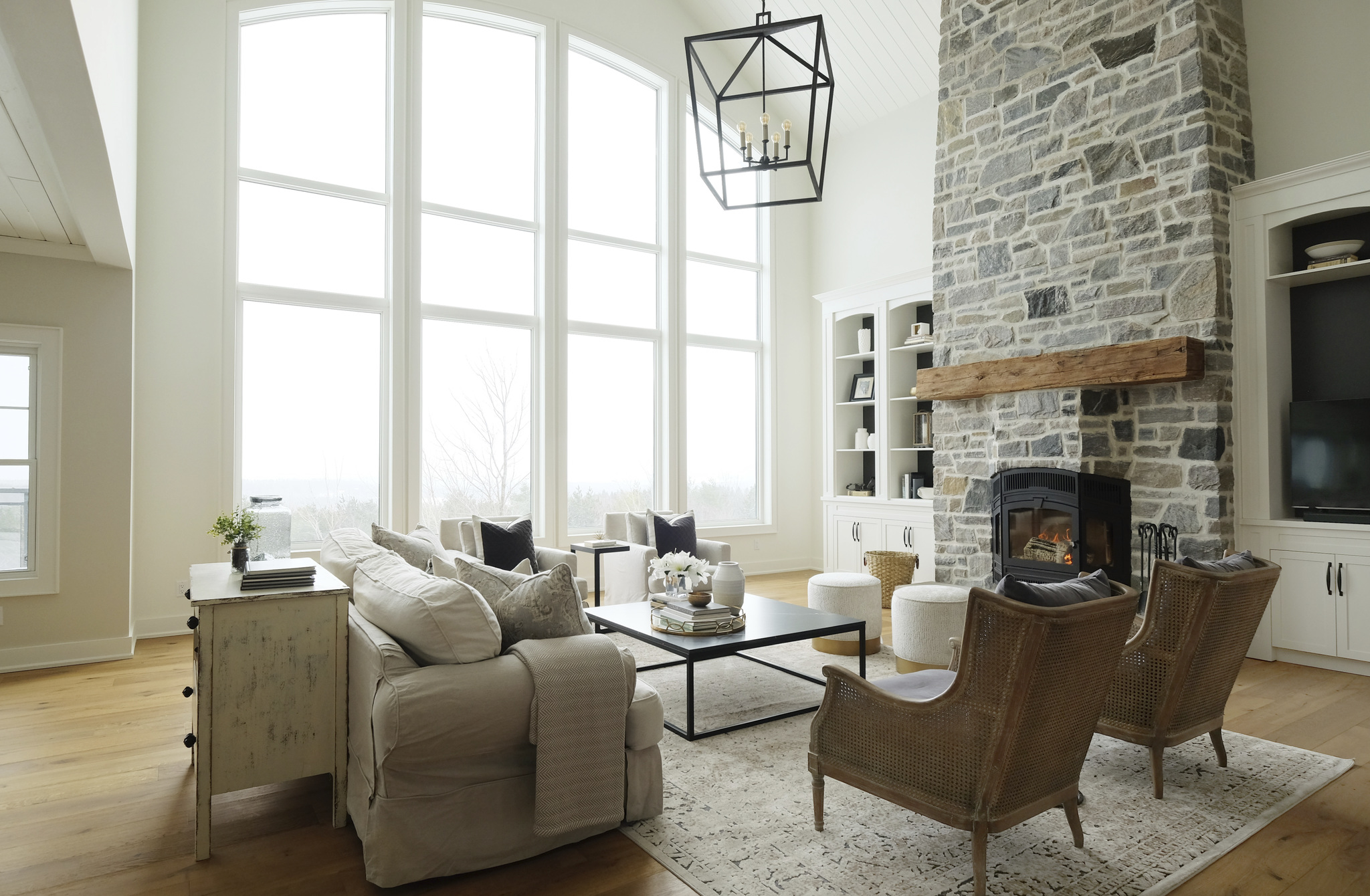 custom modern living room with sofa and seating around stone fireplace