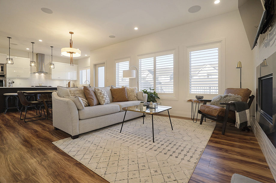 living area with dark wooden printed luxury vinyl flooring and cream sofa