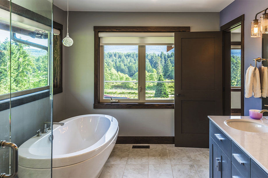 custom bathroom with destination tub and large windows 