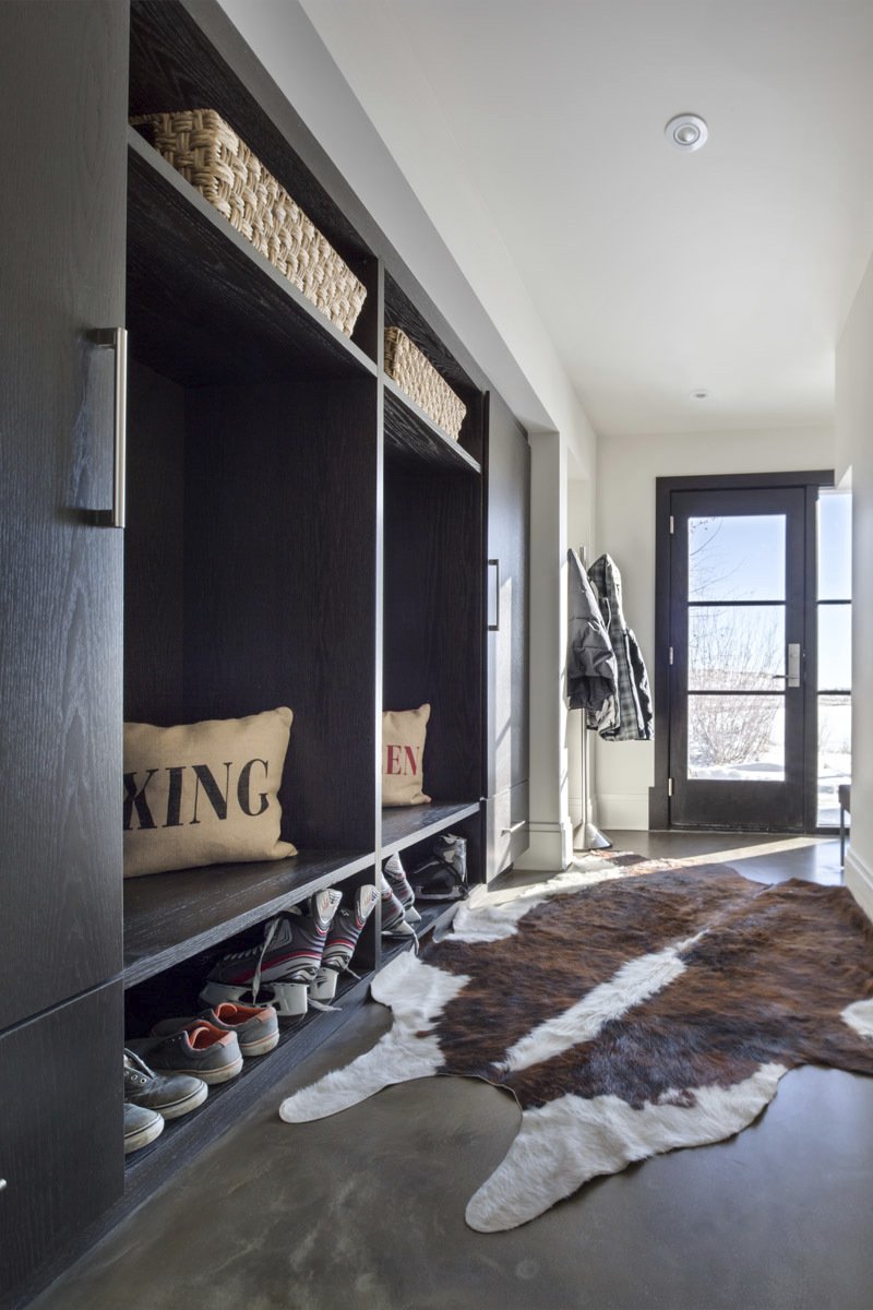 custom mudroom with statement animal rug and sliding cupboard doors