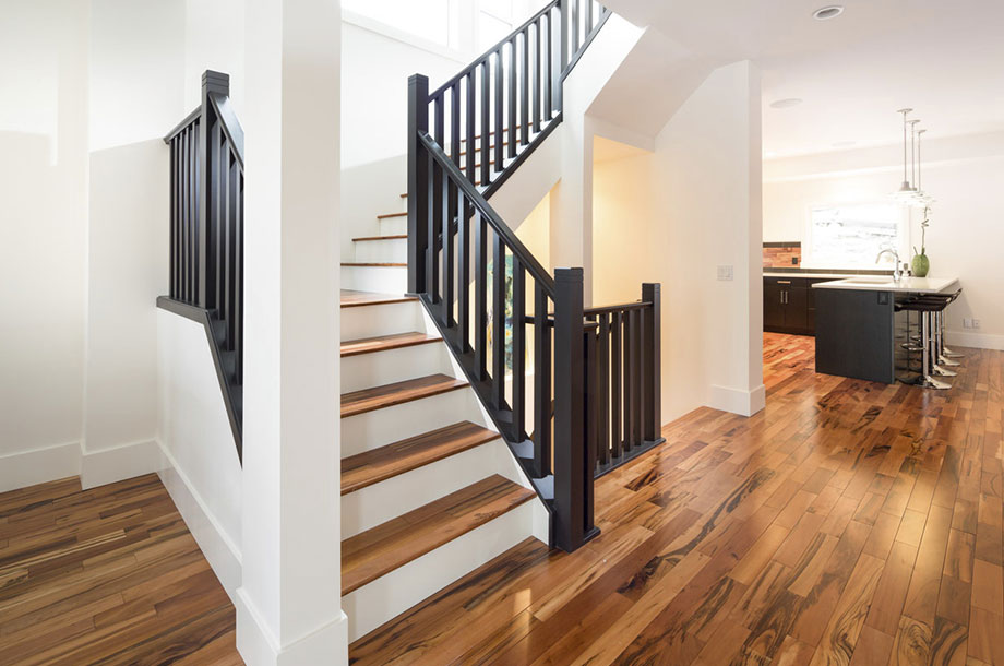 staircase with black banisters white walls luxury vinyl flooring 