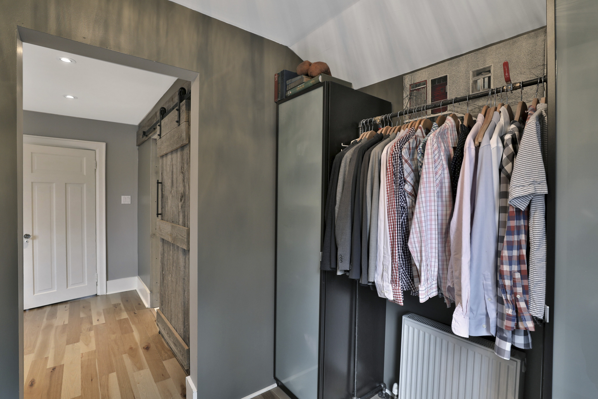 custom closet with tall black organizer and high rod with space for shoes below