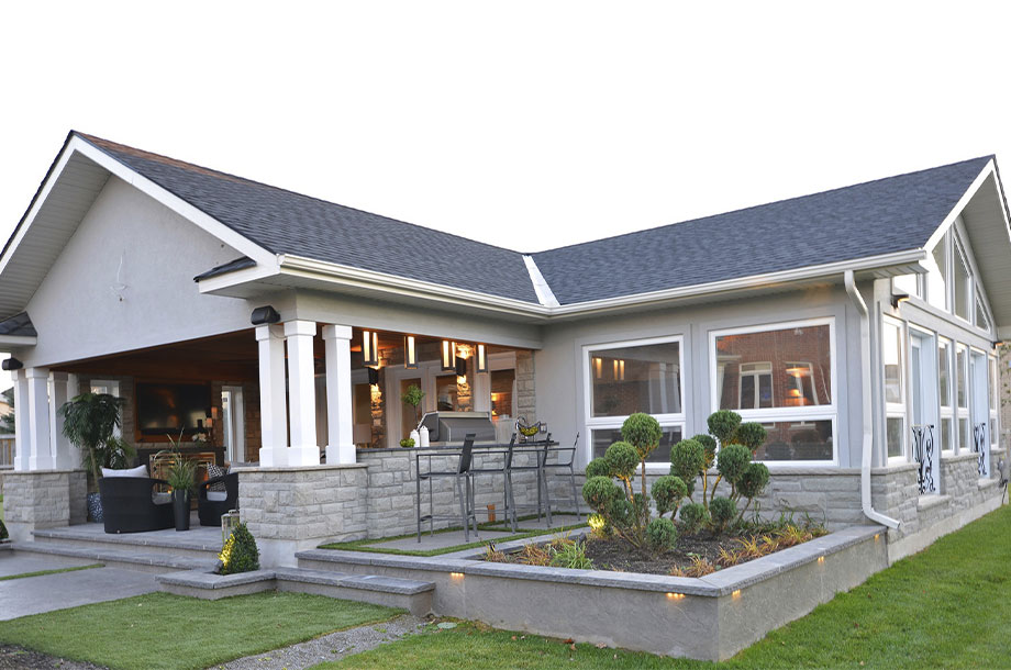 back patio of oakville home leading to turfgrass lawn and small square patch of dedicated garden