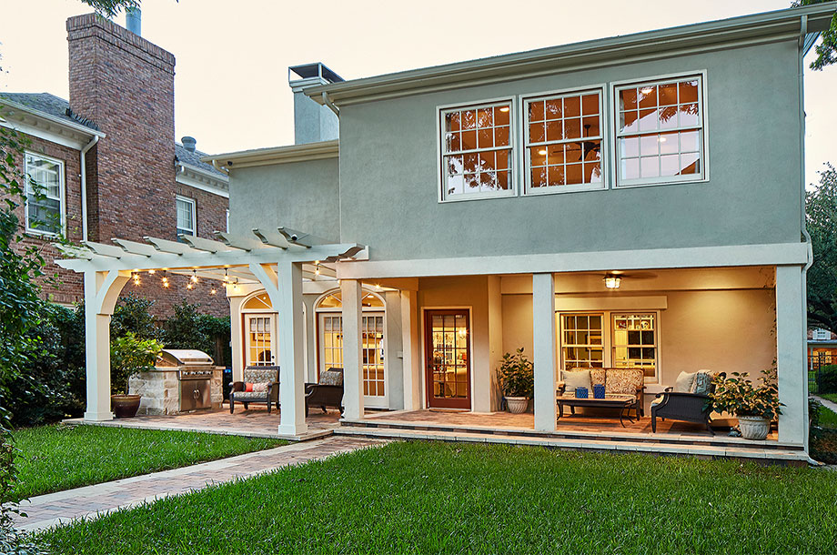 exterior of back patio of custom home with turfgrass lawn