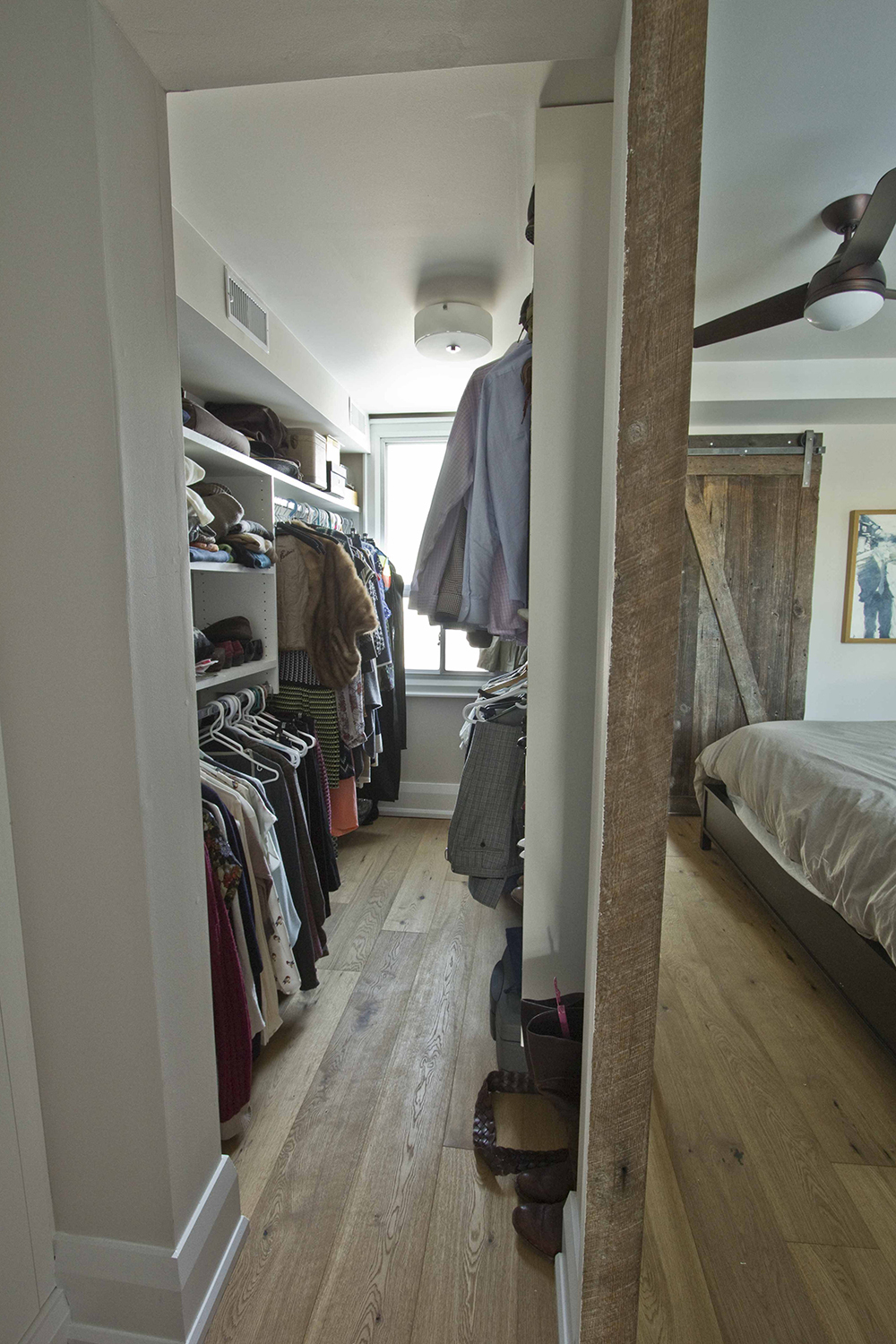 walk in closet with built in shelves for shoes on one side two hanging racks on the other