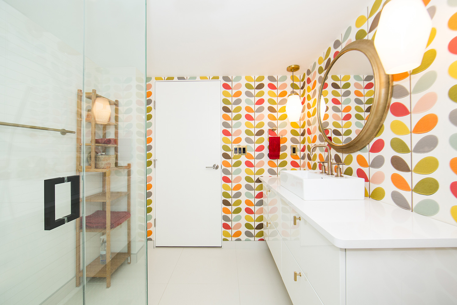 all white bathroom with multicolored bright patterned wallpaper 