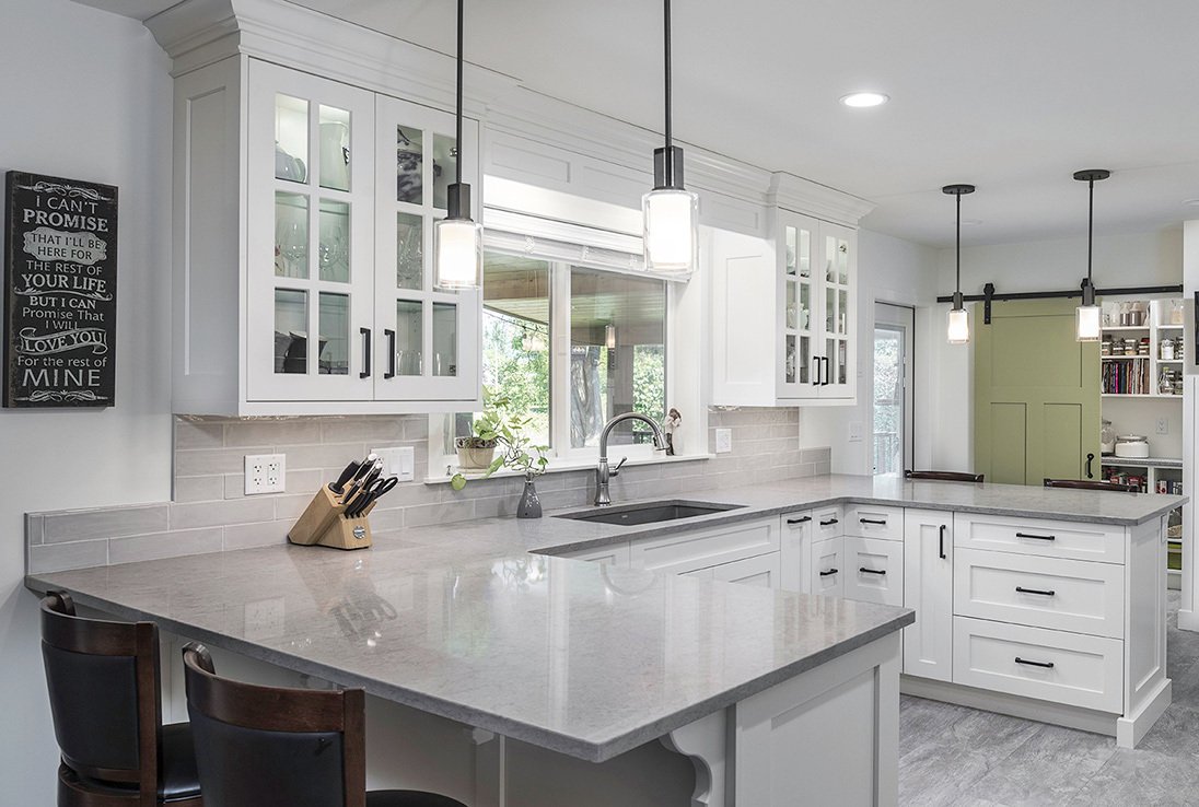 Custom Kitchen with all white, glass cabinets and green sliding pantry door