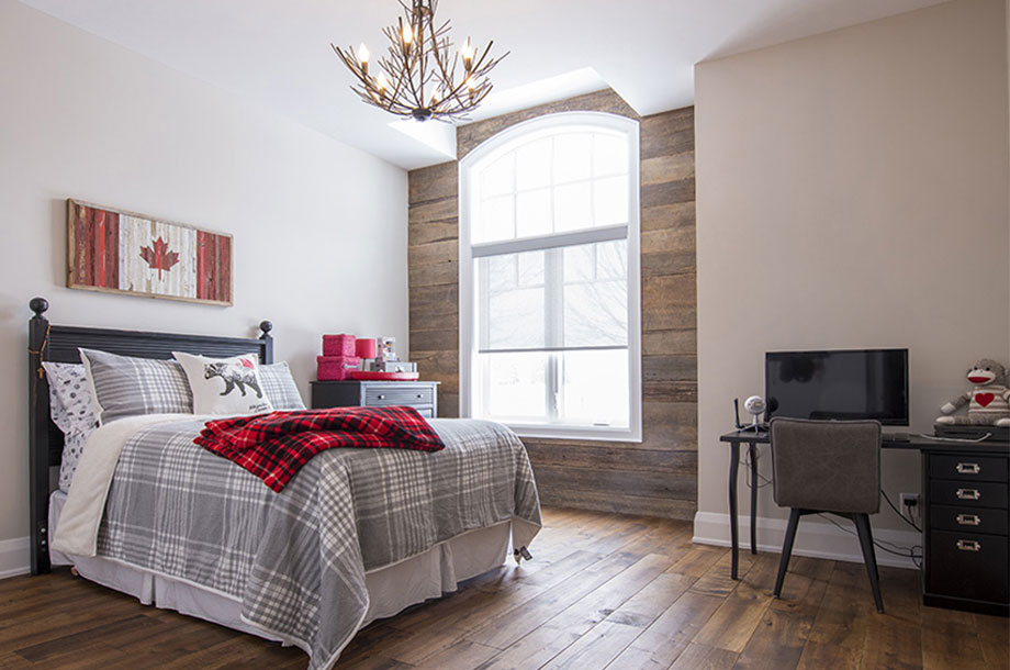 custom lighting fixture hanging over bed made of antlers