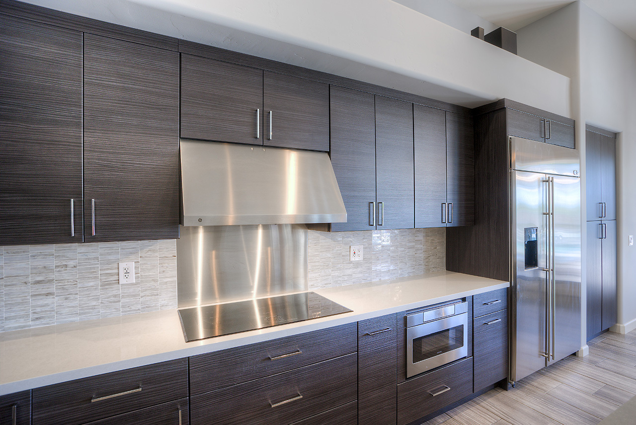 kitchen with dark wood cabinets and stainless steel finishing