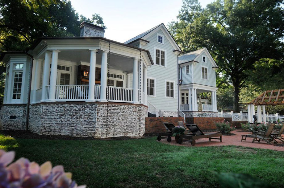 exterior of all white custom home with lush turfgrass yard