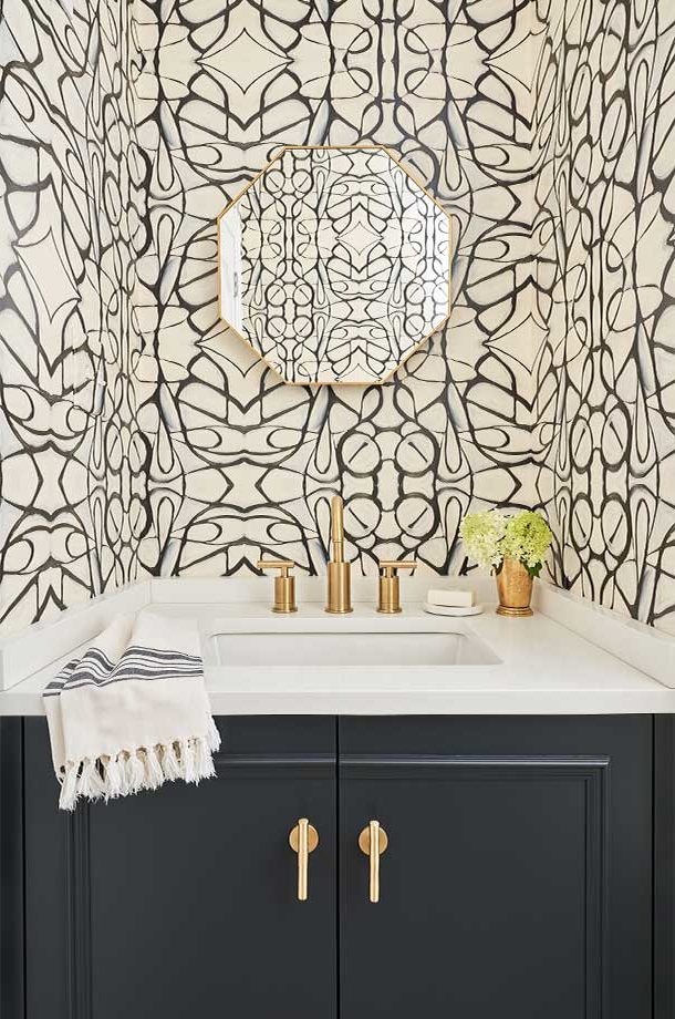 sink in custom half bath with black and white geometric wallpaper