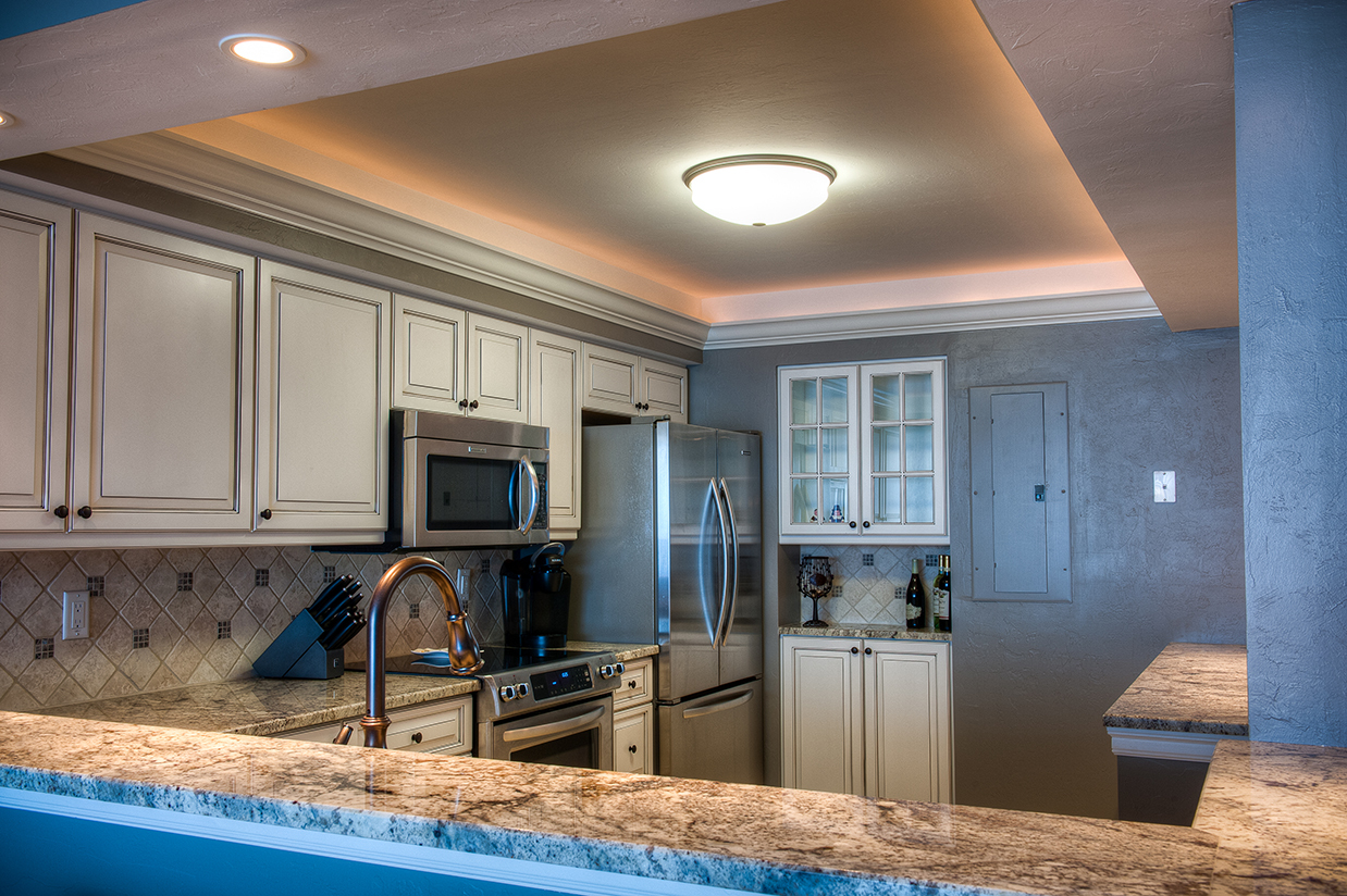 looking over bar to sanibel kitchen with inset ceiling light