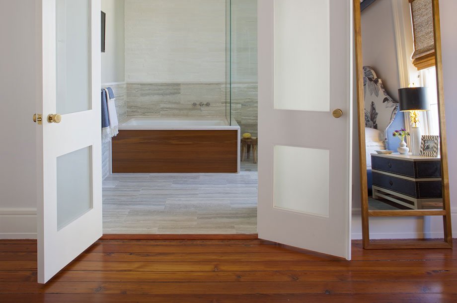 cherry vinyl flooring leading to custom bathroom