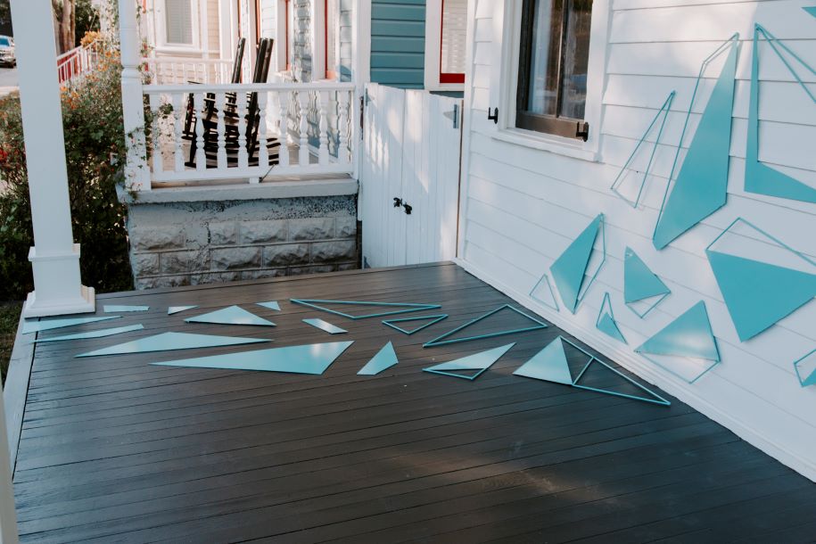 blue triangles on white porch art installation