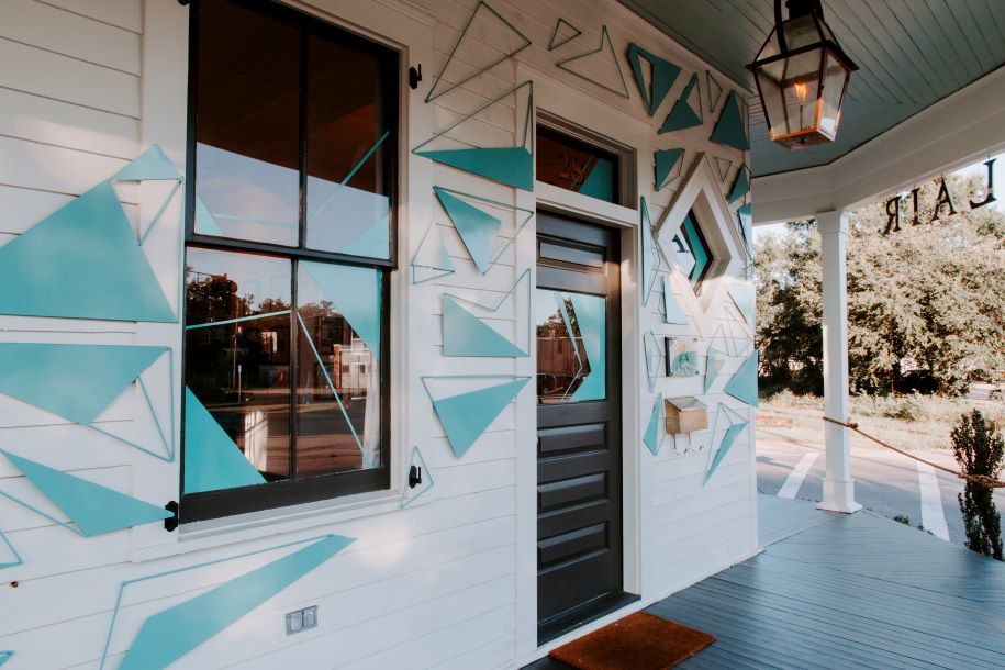 blue triangles on white porch art installation