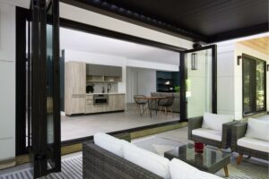 four panel glass doors open to outdoor patio