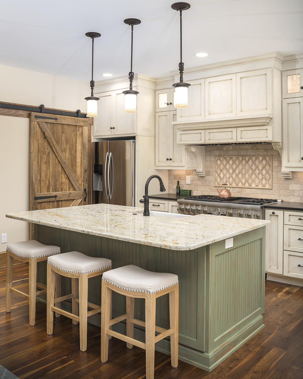 custom kitchen with natural wooden sliding pantry doors and green island