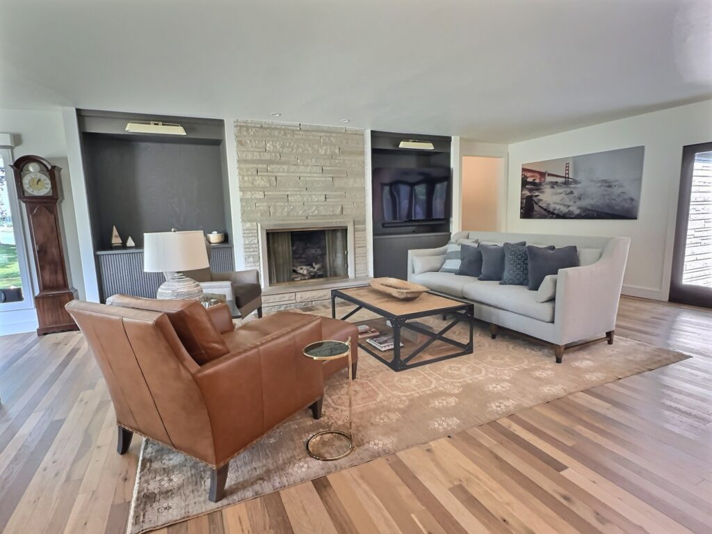 Bright, open-concept living room with updated fireplace and seating