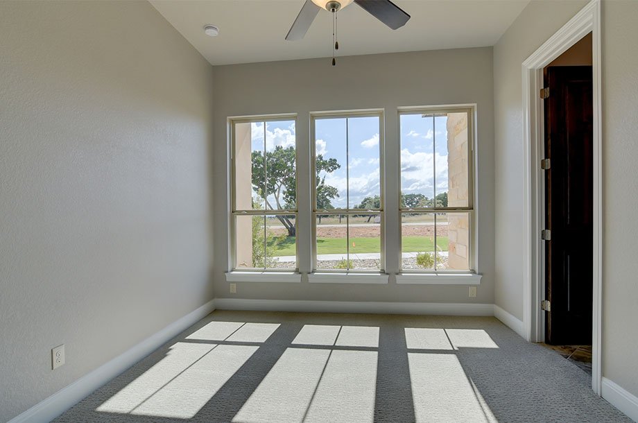 large windows overlloking front lawn of custom New Braunfels home