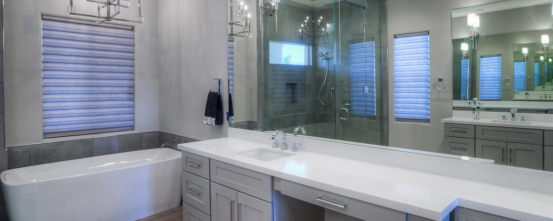 bathroom with tiled stand alone shower reflected in mirror