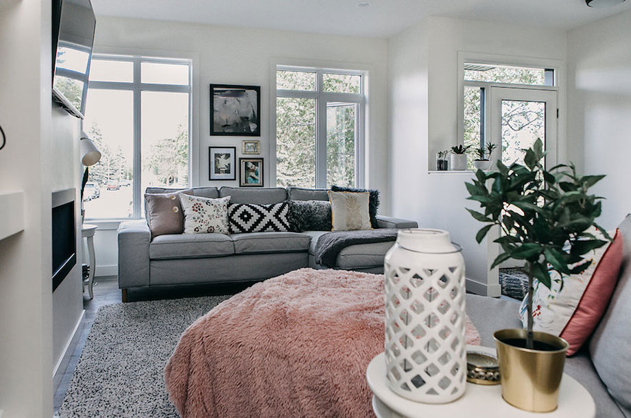 cozy living room in victoria custom home with extra blankets plants and natural lighting