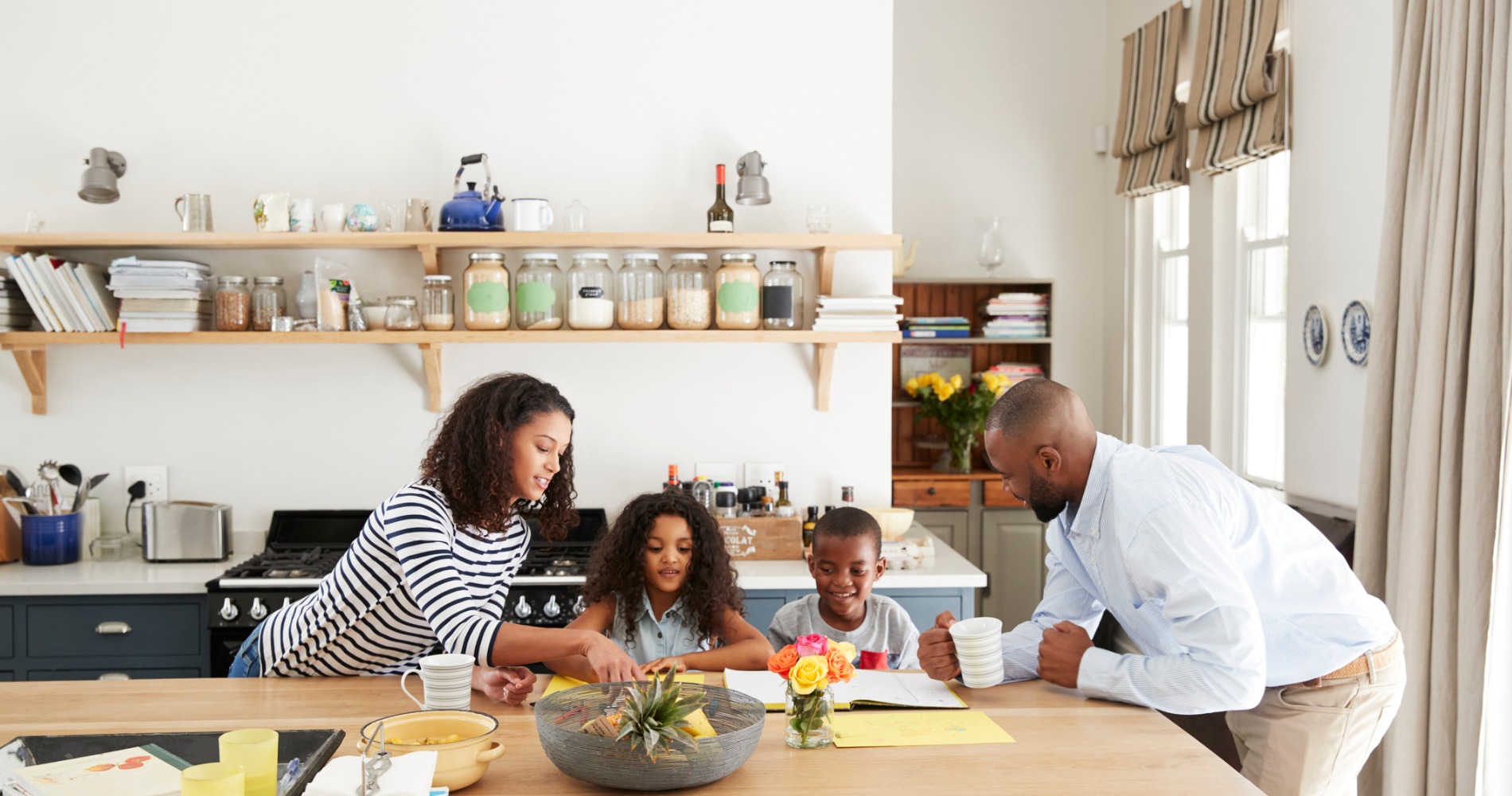 Family doing homework together in the kitchen