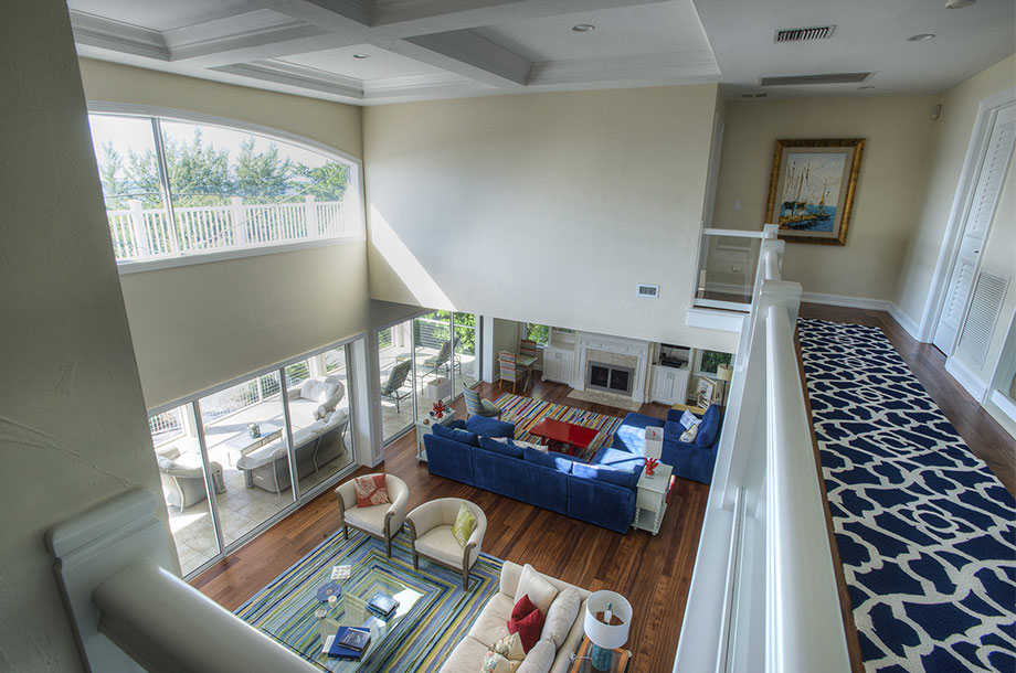 view from second story landing of bonita springs living area with vinyl flooring throughout