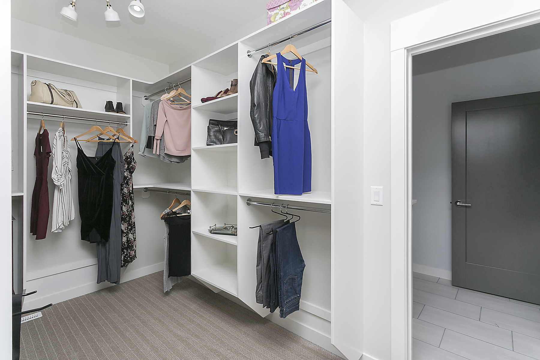 walk in closet with built in shelving units multi-level hanging rods